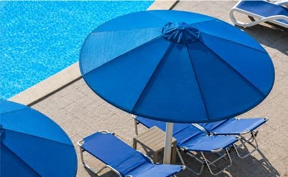 Parasols and folding loungers by the pool at Beach Albatros